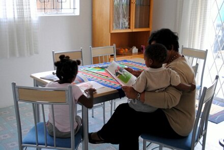 Foster mother reading with children